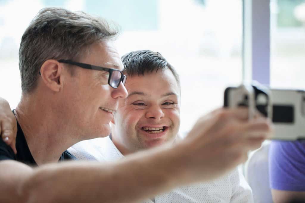 Father and son smiling and taking a selfie